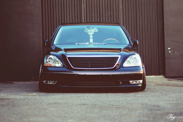 A tuned Lexus standing at the gate