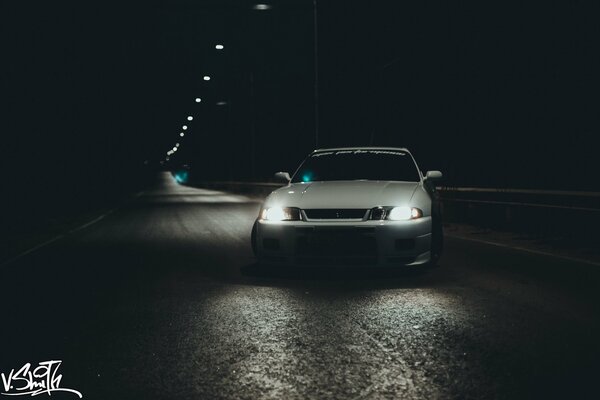 A white car on a wet road