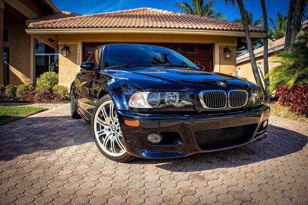 BMW car on the background of a country cottage