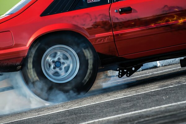 The smoking wheel of a racing car