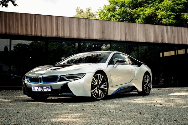 White BMW on the asphalt near the house