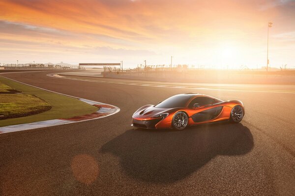 Orange mclaren on the race track