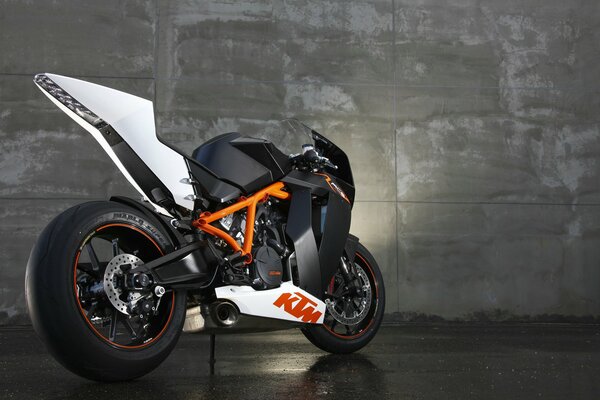 Das ktm rc8 Sportbike steht vor dem Hintergrund einer Betonwand