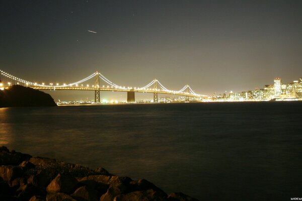 Ночной пейзаж с освещённым иллюминацией мостом