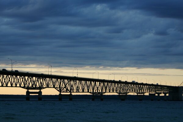 Cars are moving on a wide bridge over the strait