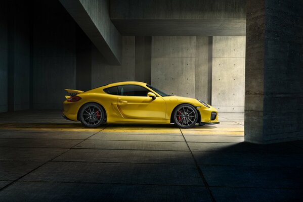 Yellow supercar in a covered parking lot