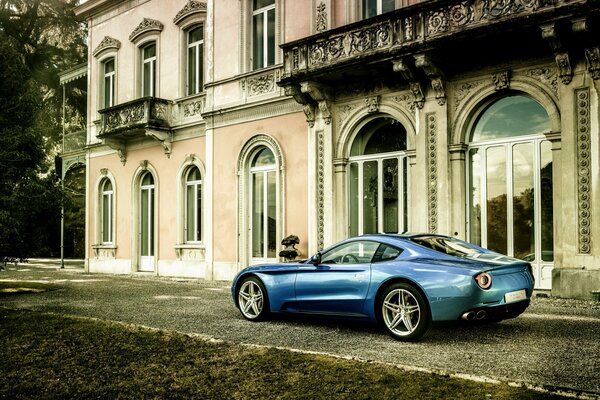 Beautiful blue Ferrari Berlinetta on the background of an old mansion