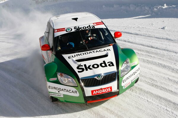 Sports Skoda Fabia goes into a snow-covered turn