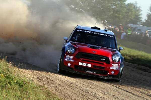 Red mini cooper brand car in motion at the races