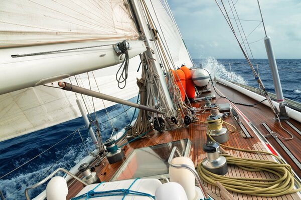 Splashing waves on the deck of a yacht under sail