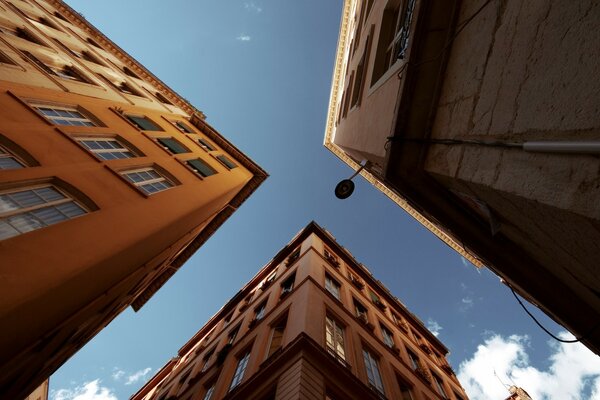 Three corners of buildings and the sky photo from below