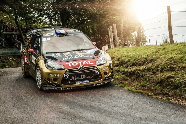 Black and gold citroen ds3 participating in the rally