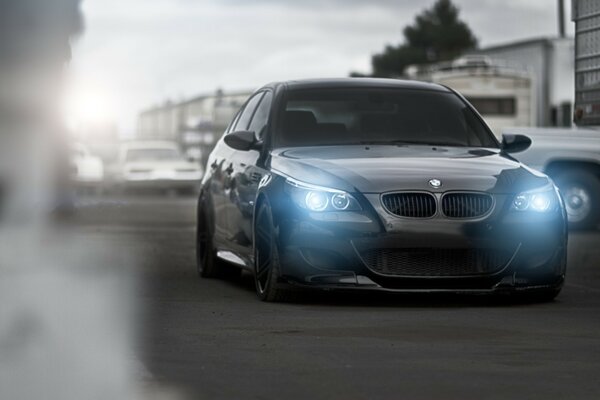 Black BMW sedan lights up