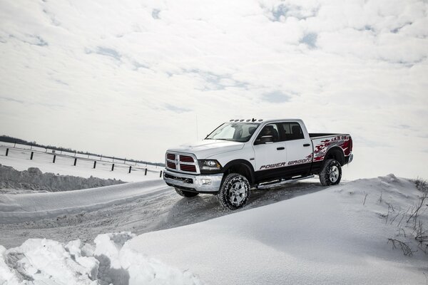 Powerful Dodge pickup truck on a snowy background