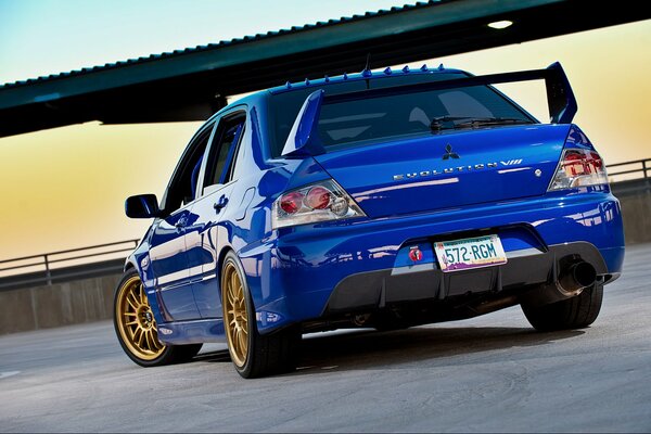 Blue Mitsubishi at sunset