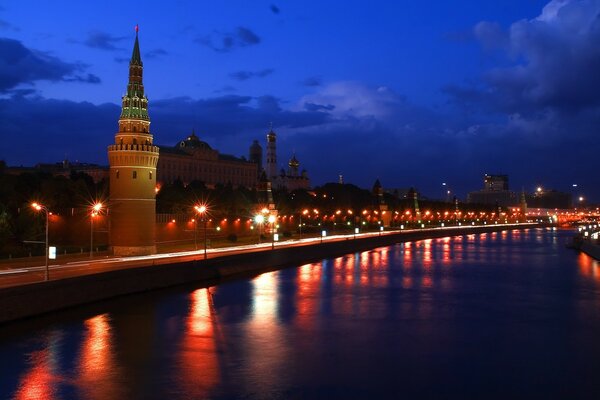 The Moscow Kremlin is reflected in the river at night