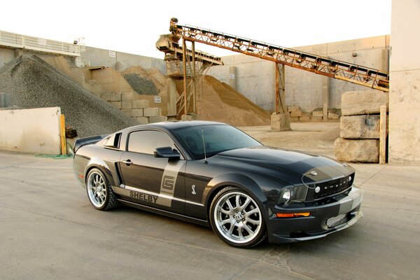 Ford Mustang on the background of construction