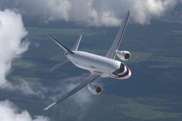 Super jet 100 aircraft in flight over the ground