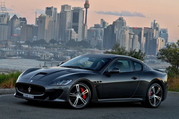 New black maserati on the background of the metropolis