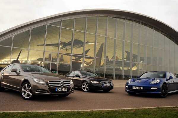 Audi Porsche and Mercedes at the building