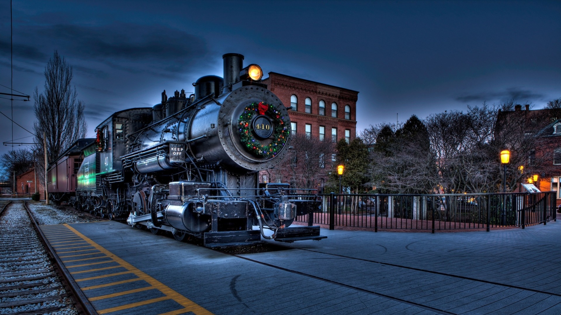 in the evening tracks locomotive train wreath town