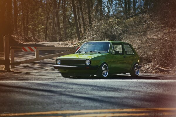 Green VOLKSWAGEN MK1 on a retro forest background