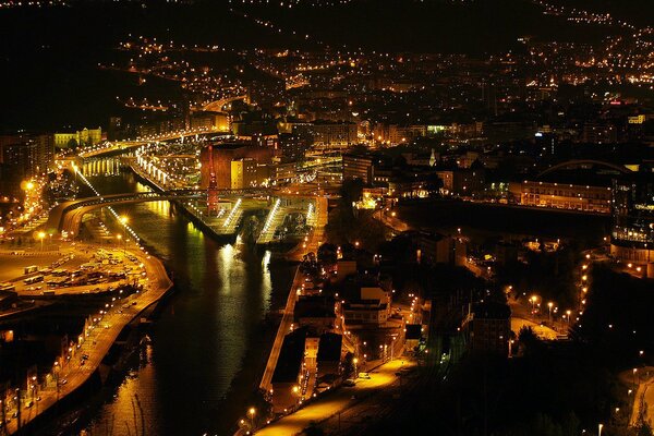 The beauty of the night city, the view of the river and the bridge