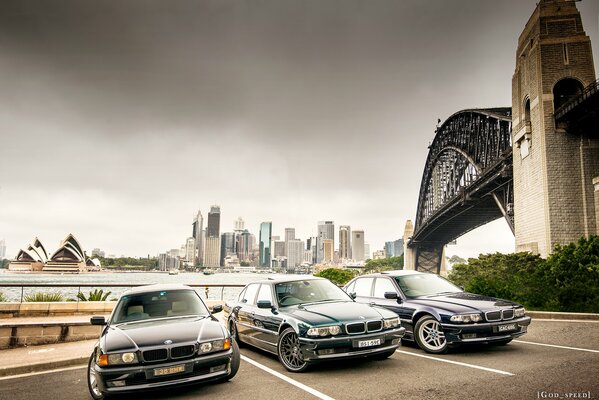 Three BMW models against the background of urban buildings