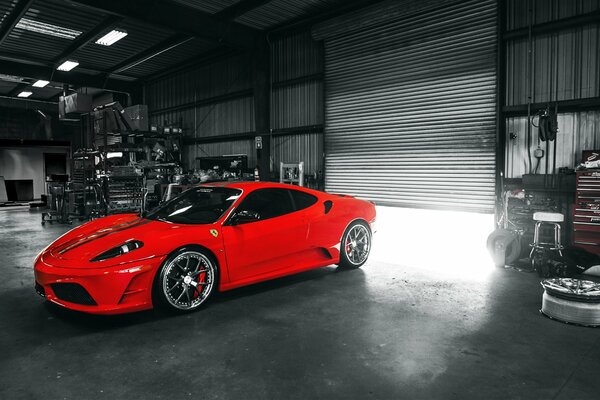 A red Ferrari sports car in the garage