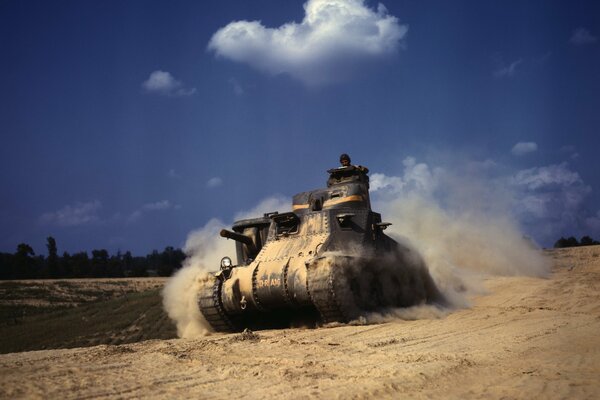 Military equipment in motion. tank in the dust