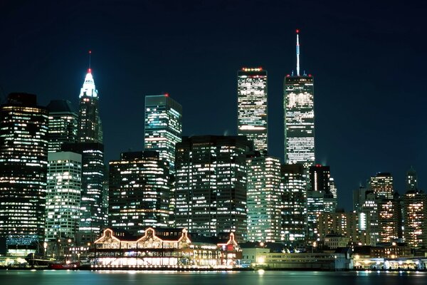 The lights of New York at night. The surface of the night river