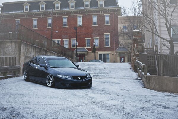 A car is driving through the winter city