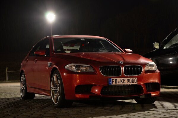 Red BMW on the evening streets