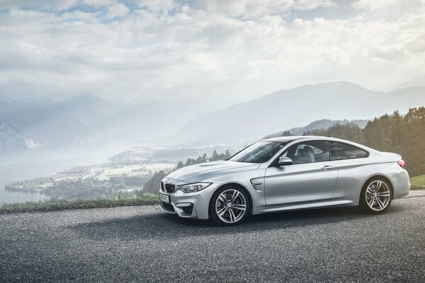 A silver car is standing at the cliff