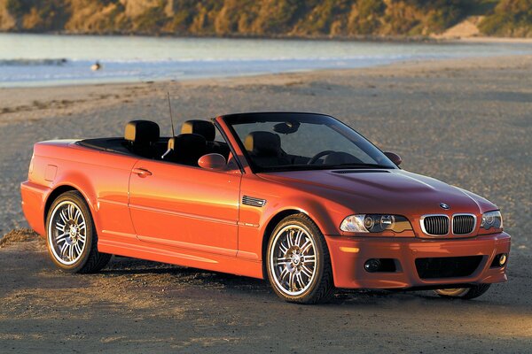 Red bmw e46 convertible on the shore in profile