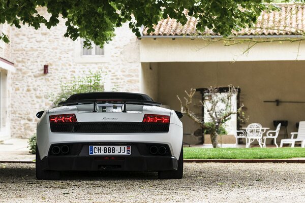 Lamborghini lp 570-4 is parked in the yard at the house