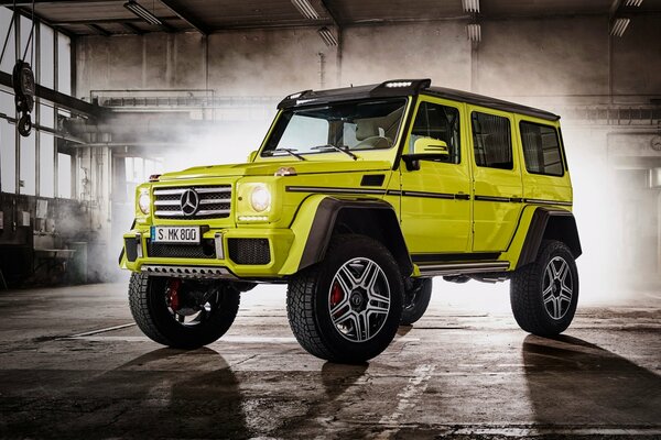 Light green Mercedes-benz car on the background of fog in the garage