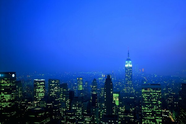 Glowing skyscrapers against the blue sky