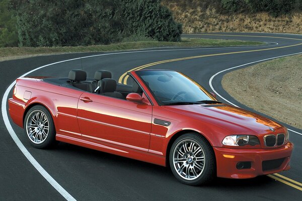 Red bmw e46 convertible on a winding road