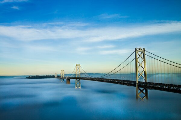 A bridge that goes into the water and fog