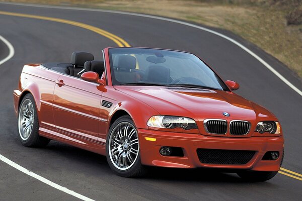 Red bmw e46 convertible on the road in motion