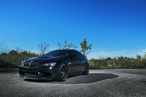 Black matte BMW on asphalt