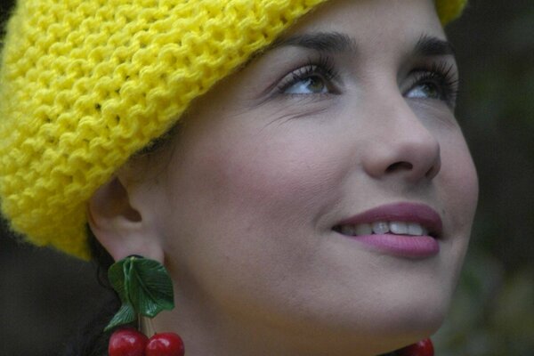 Romantic girl in a knitted yellow beret