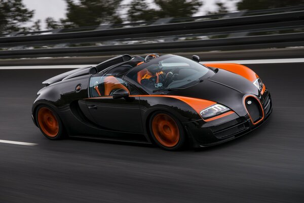 Black and orange sports car on the road