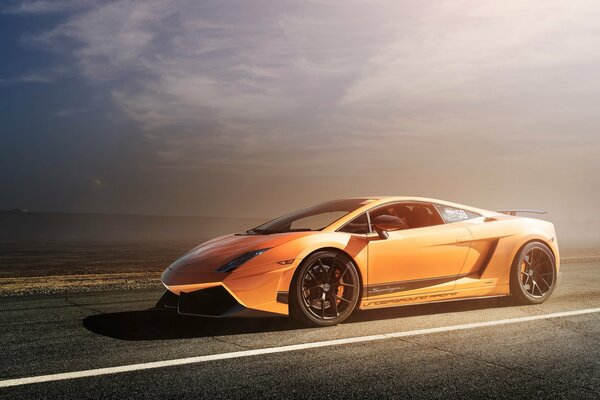 Orange and gold car on a clear sky background