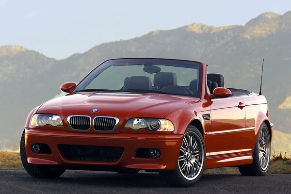 Red bmw e46 convertible in the mountains