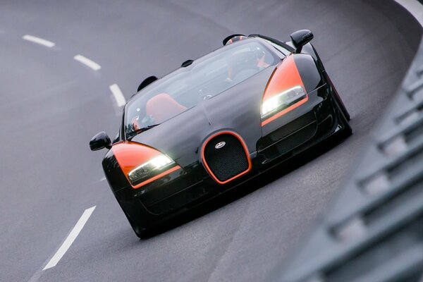 Bugatti veyron car in black and orange on the highway