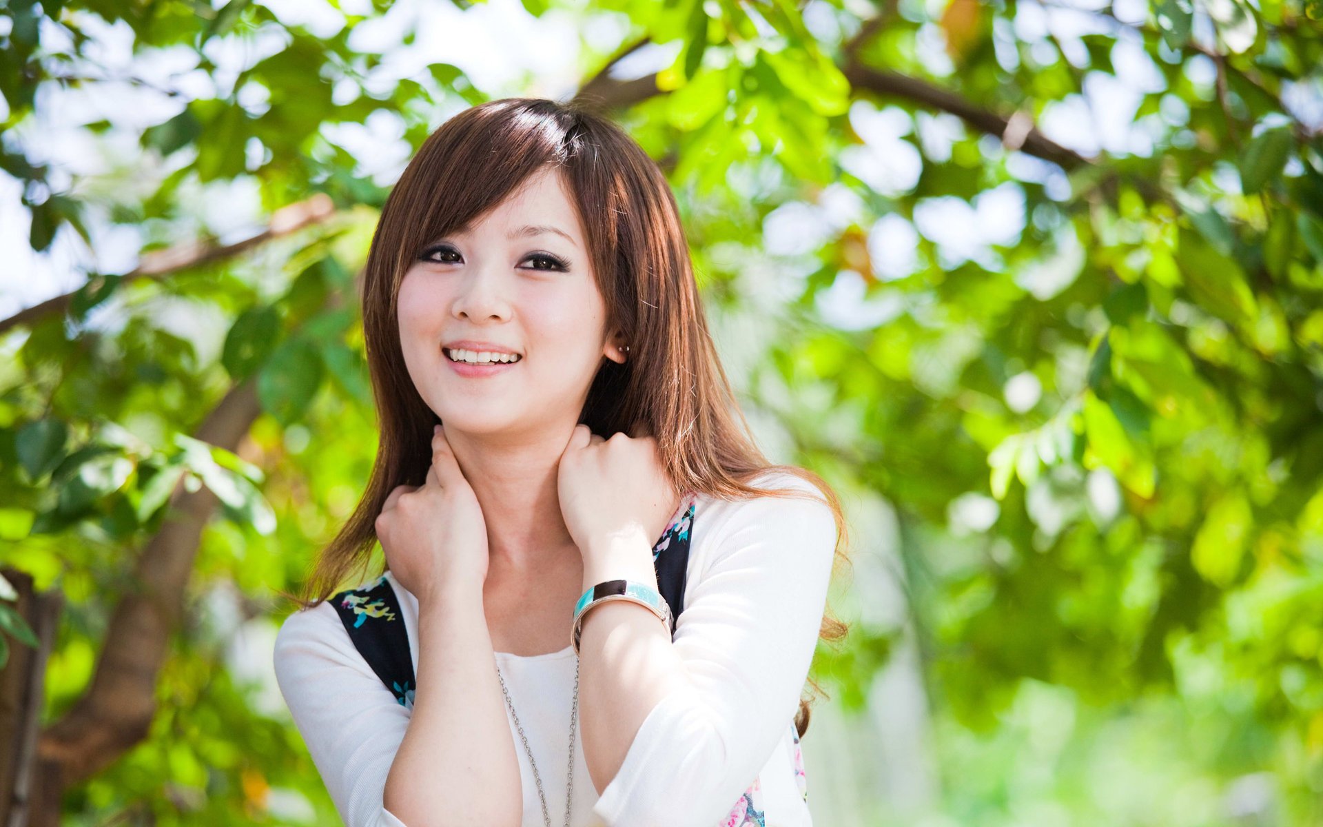 girl asian smile trees foliage greens leaves hair brown hair eyes look