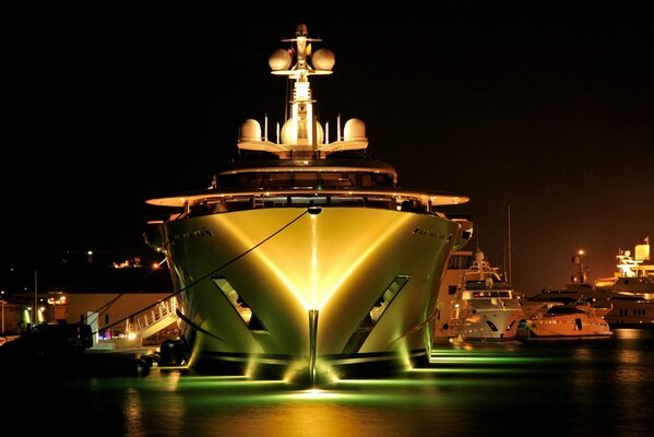 Image of a mega yacht on the background of night lights