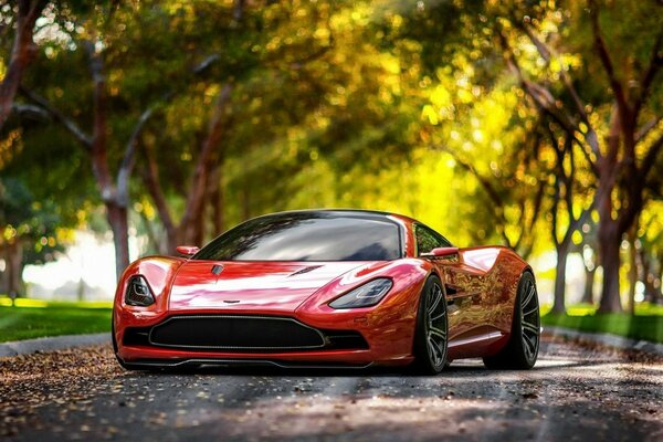 Крутой aston martin словно весело подмигивает